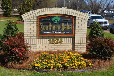 Outdoor brick sign for Southern Oaks Nursing & Rehabilitation Center, LLC with flowers in front.