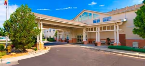 Exterior view of Avamere at Rio Rancho entrance with a covered driveway