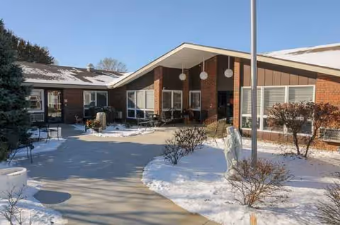 Front exterior of Life Care Center of Seneca with a snow-covered walkway and patio.