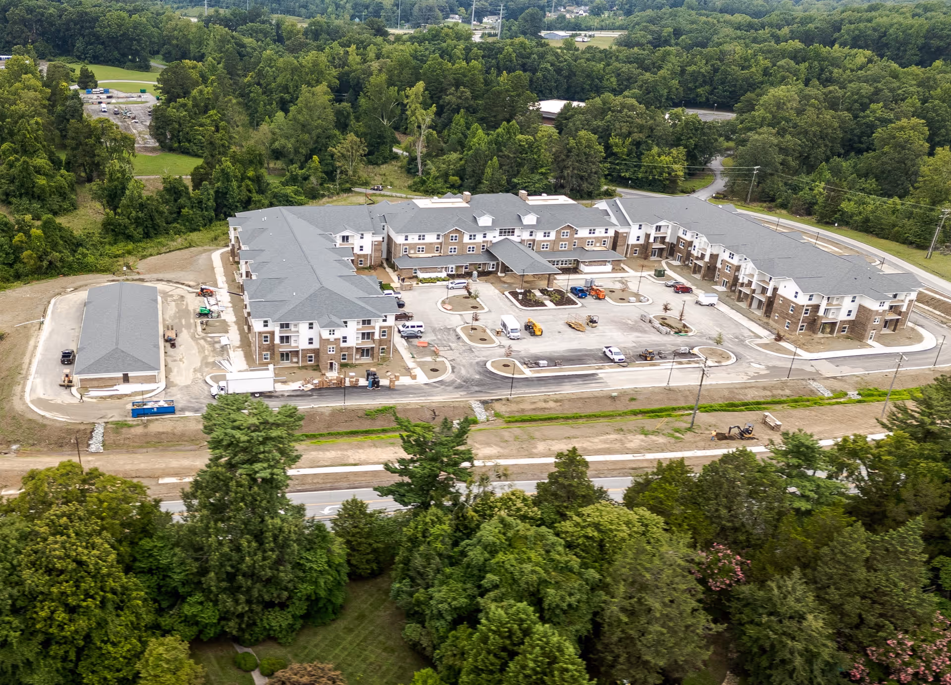 Aerial view of the Carolina Pines Retirement facility showing multiple buildings, parking areas, and surrounding greenery.