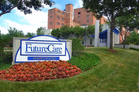 Exterior view of FutureCare Homewood with a landscaped sign and brick building.