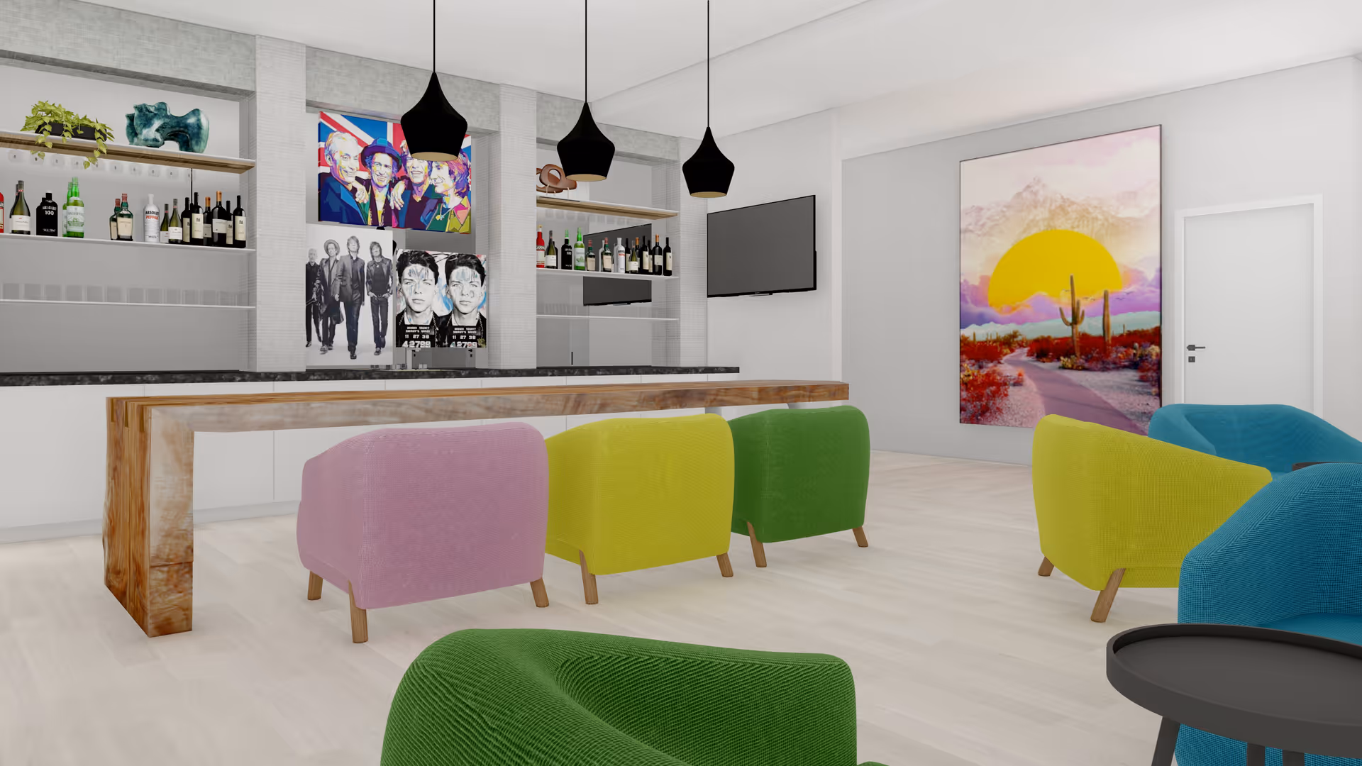 A modern lounge area with colorful armchairs in pink, yellow, green, and blue arranged around a wooden bar counter. Behind the bar are shelves stocked with bottles and three black pendant lights hanging from the ceiling. The walls feature vibrant artwork, including a large painting of a desert scene with a yellow sun and cacti, and a set of pop art portraits. A flat-screen TV is mounted on the wall.