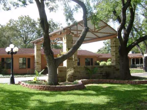 Exterior view of Care Nursing and Rehabilitation with a covered entrance and green lawn.