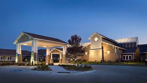 Exterior view of Southlake Village Rehabilitation and Care Center entrance with canopy and landscaping.