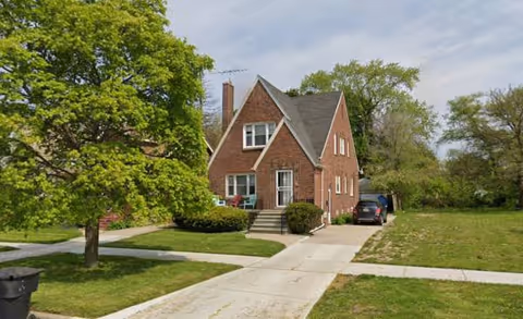 Brick We Care Lappin senior living building with front lawn and driveway.