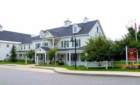 Greystone Farm at Salem exterior front view of a light-colored, multi-story assisted living building.