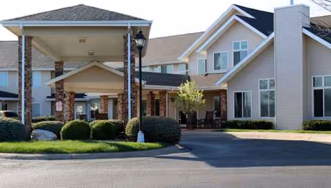 Exterior view of Linden Estates with covered entrance, pillars, and landscaped driveway.