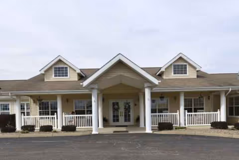 Front entrance of a single-story senior living facility with a covered portico.