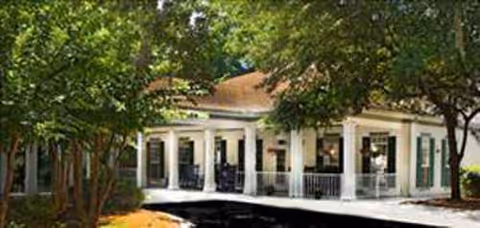 Front view of a River Oaks senior living facility with columns and a covered porch.