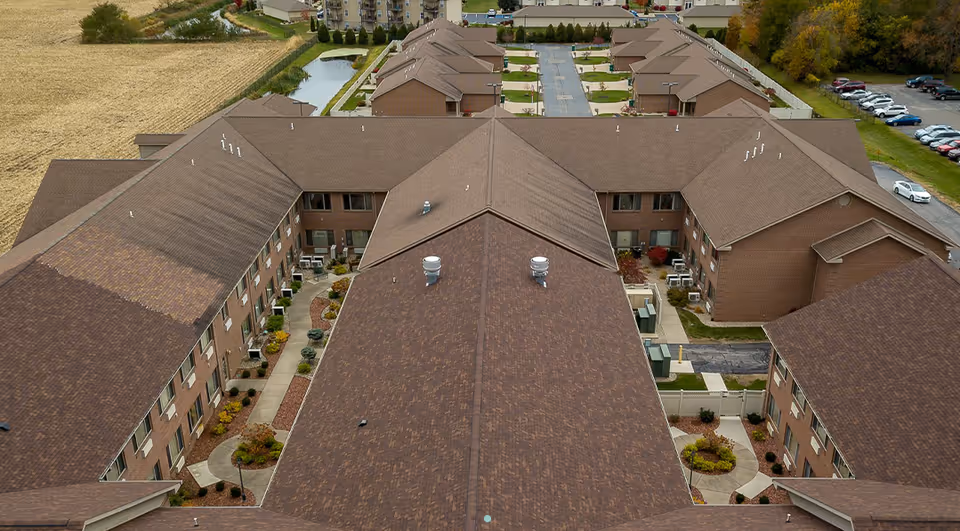 Aerial view of Brentwood at LaPorte senior living campus with brown rooftops.