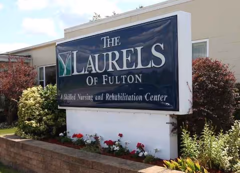 Large sign reading The Laurels of Fulton with landscaping in front of a facility.