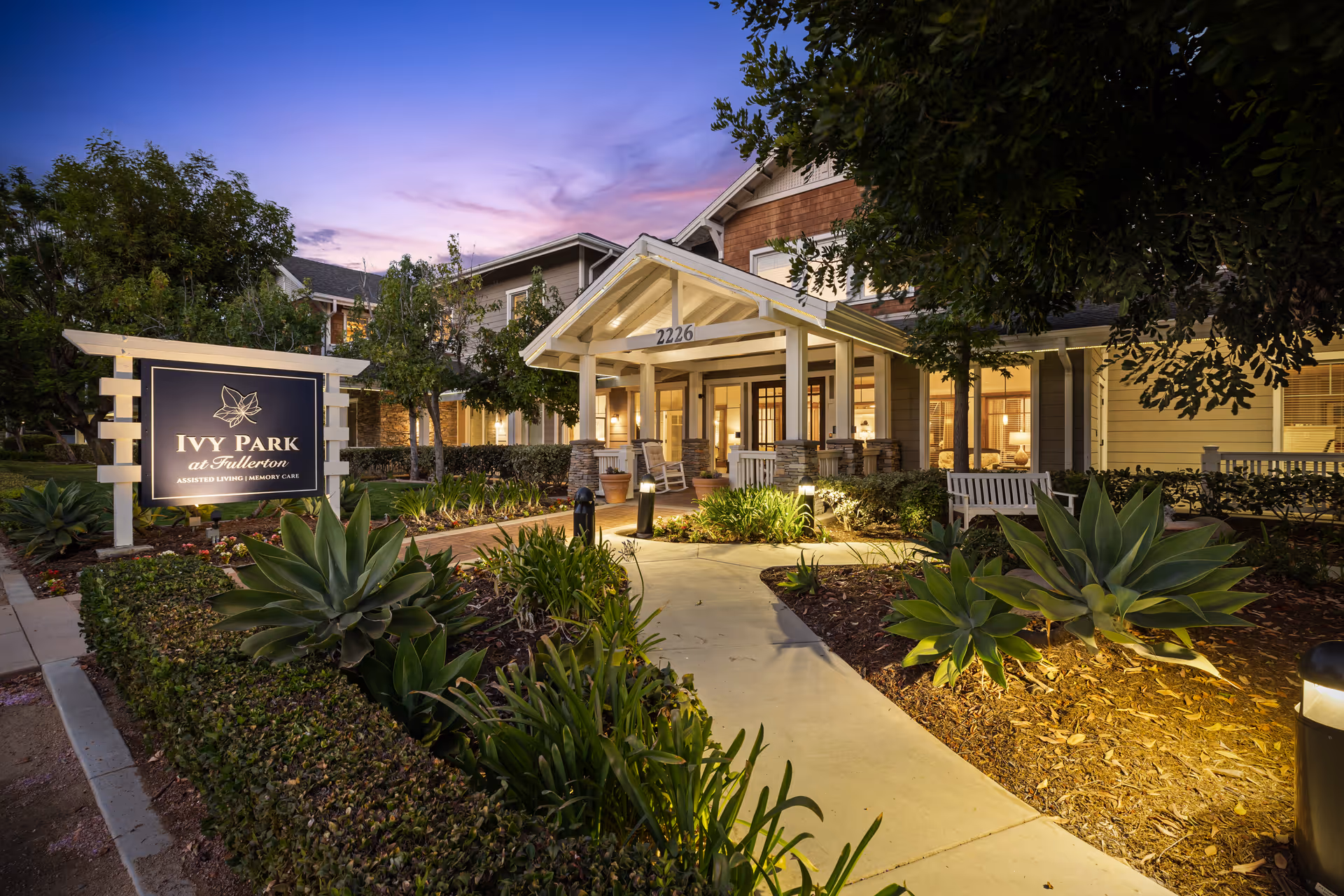 Exterior view of Ivy Park at Fullerton entrance with landscaped path and sign