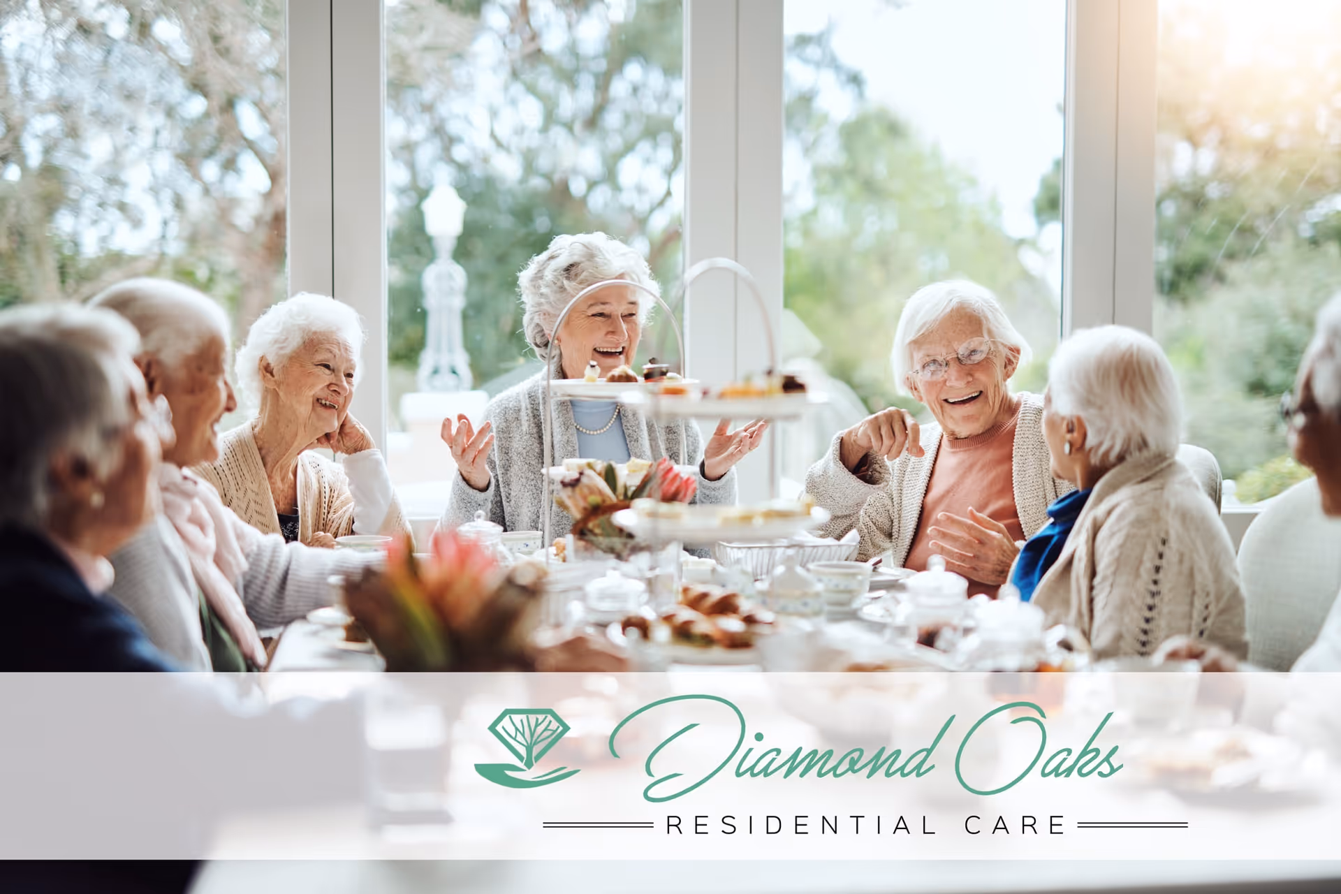 A group of elderly residents sitting around a table enjoying tea and pastries in a bright dining room.