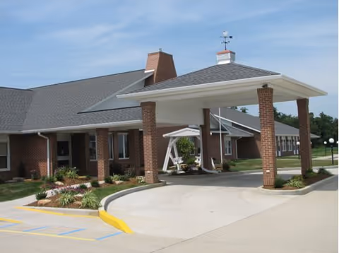 Brick entrance with a covered porte-cochere and driveway at Parkview Village Christian Care.