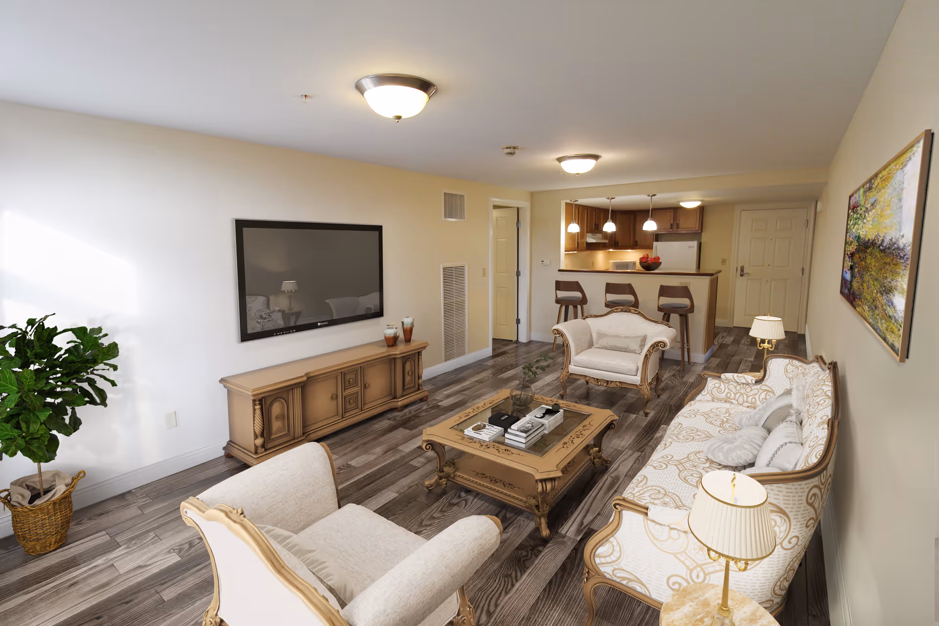 A bright and spacious living room with classic-style furniture including a sofa, two armchairs, and a coffee table. A flat-screen TV is mounted on the wall above a wooden TV stand. The room has wooden flooring, a potted plant in the corner, and a painting on the wall. In the background, there is a kitchen area with a breakfast bar and three bar stools, illuminated by pendant lights.