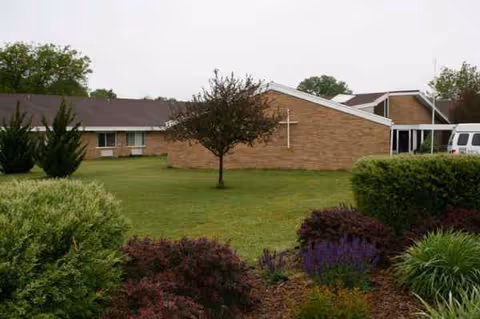 Exterior view of Mount Joseph Senior Village showing a brick building and well-kept lawn