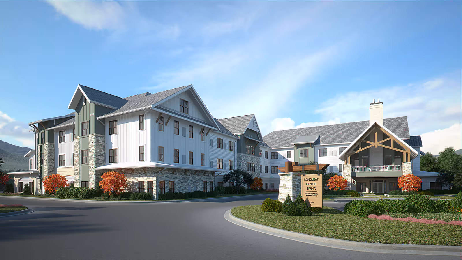 Exterior view of Longleaf Liberty Park senior living facility showing a large, modern three-story building with stone and white siding, surrounded by landscaped greenery and a clear blue sky.