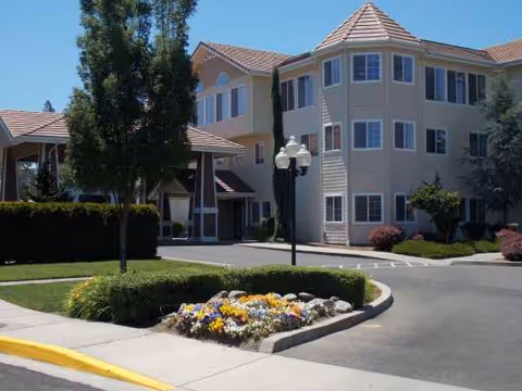 Exterior view of Countryside Village senior living facility with a landscaped entrance and driveway.