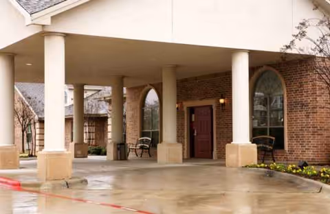 Entrance of McKinney Healthcare and Rehabilitation Center with a covered drop-off area.