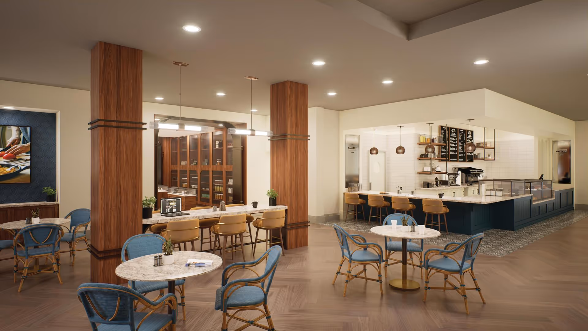 A modern dining area with round marble tables and blue cushioned chairs. There is a long counter with tan chairs and pendant lights hanging above it. The background shows a kitchen or serving area with shelves, a coffee machine, and menu boards. The space has wooden flooring and warm lighting.