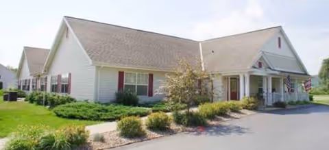 Brookdale Winona single-story senior living facility with a front entrance, manicured landscaping, and American flags.