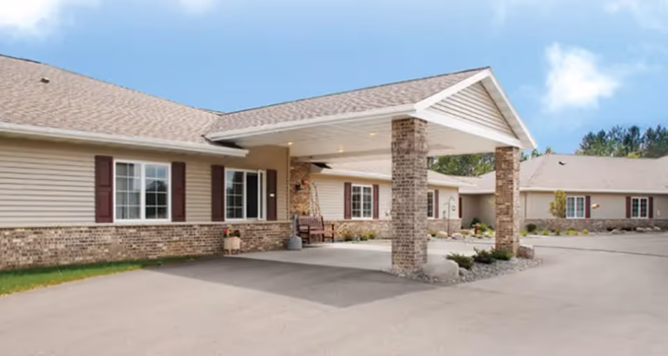 Exterior view of a Carefree Living McGregor facility with a covered entrance and brick columns.