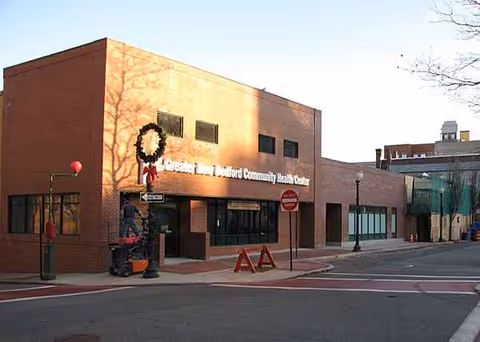 Exterior view of CareOne at New Bedford Community Building with wreaths on the facade.