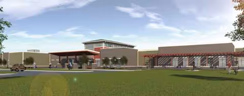 Exterior view of Wellbrooke of Kokomo showing a lawn, entrance canopy, and parking.