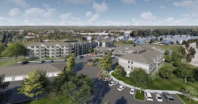 Aerial view of the Rivertown Ridge senior living campus with multiple residential buildings, parking areas, and landscaped grounds.