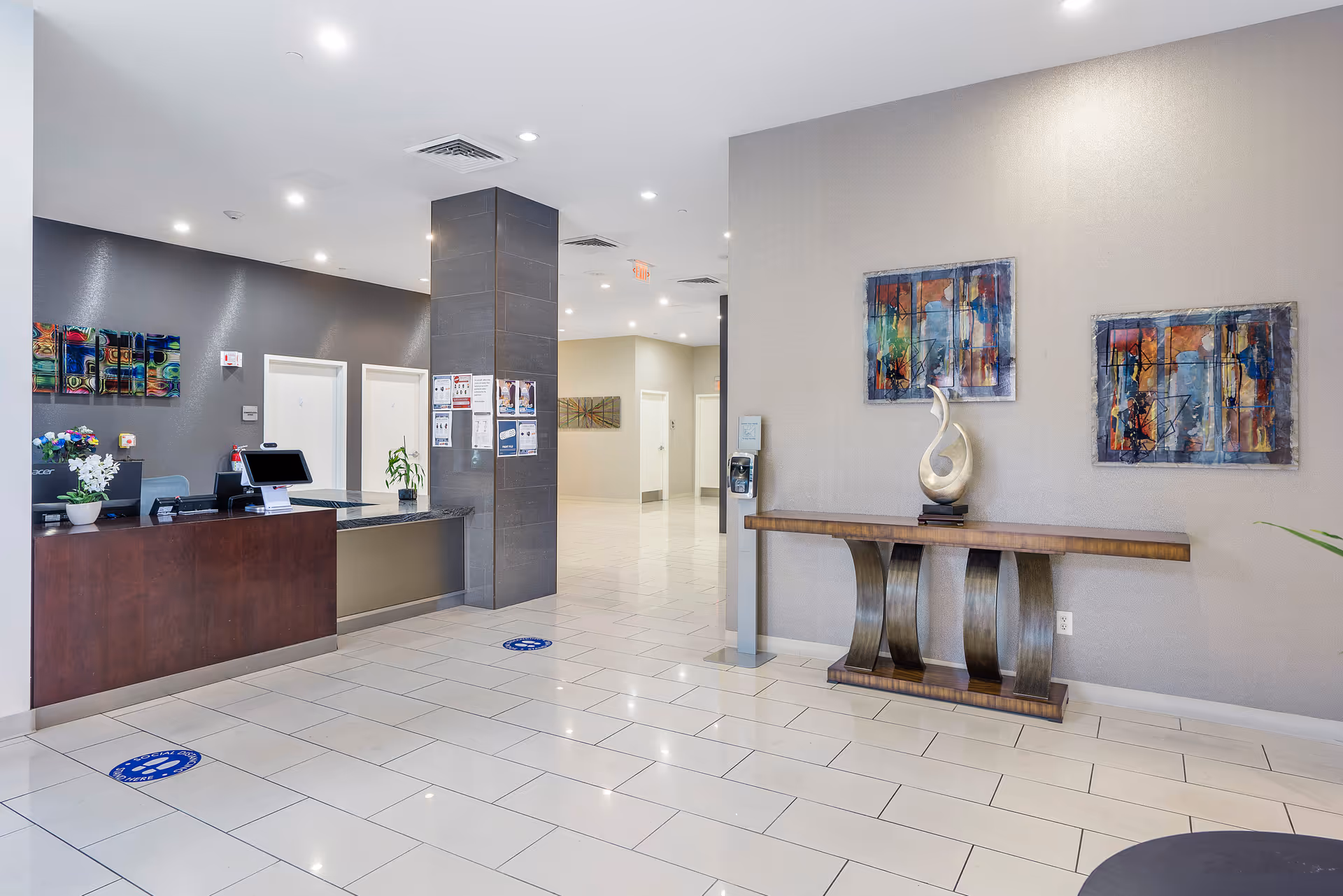 University Health & Rehabilitation Center lobby with reception desk, tiled floor, and wall art.