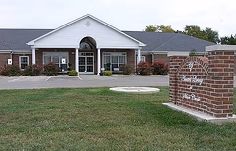 Exterior view of The Assisted Living at Silver Creek with brick entrance sign.