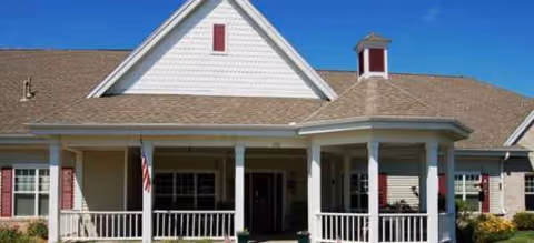 Front view of Brookdale LaCrosse building with a covered porch and flag.