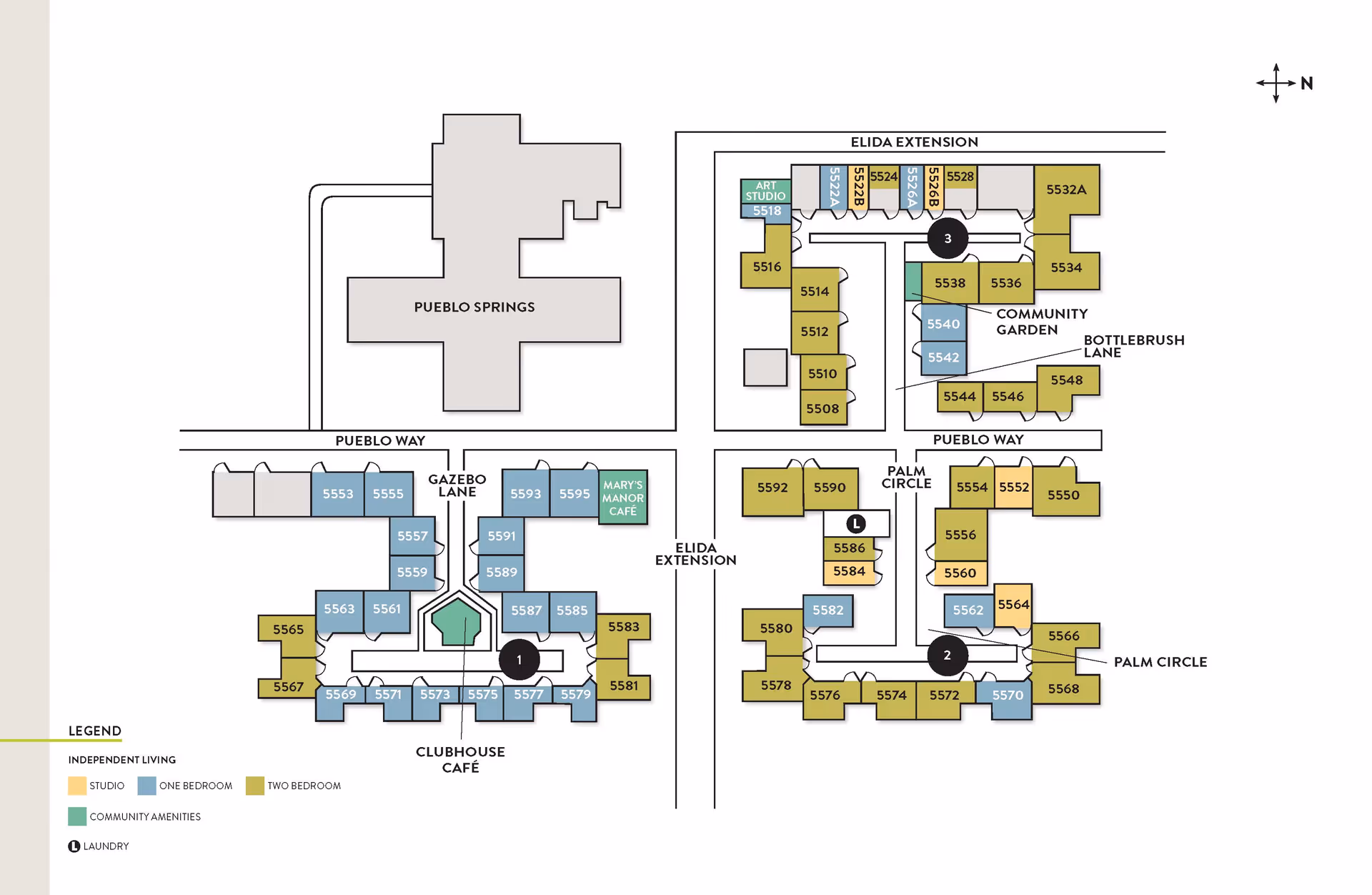 Floor plan of Atria Valley Manor showing independent living units and community amenities. The layout includes Pueblo Springs, Elida Extension, Gazebo Lane, Palm Circle, and Bottlerbrush Lane. Units are color-coded by type: studio, one bedroom, and two bedroom. Community amenities such as an art studio, Mary's Manor Café, clubhouse café, community garden, and laundry locations are marked. A compass indicates north direction.
