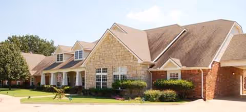 Exterior view of Brookdale Bartlesville South facility with landscaped entrance and brick facade.