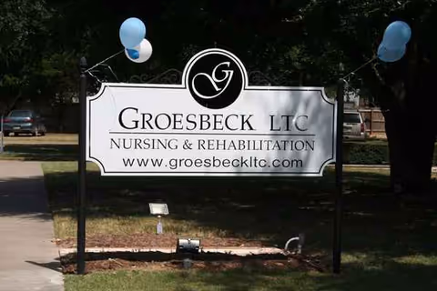 Outdoor sign displaying Groesbeck LTC Nursing & Rehabilitation with balloons on either side.