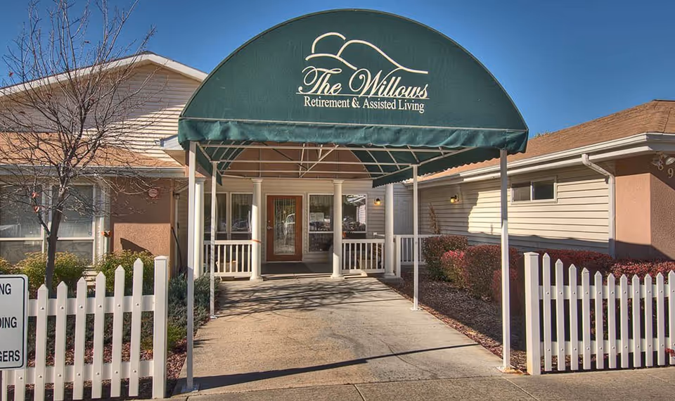 Front entrance of The Willows Retirement and Assisted Living under a green canopy.