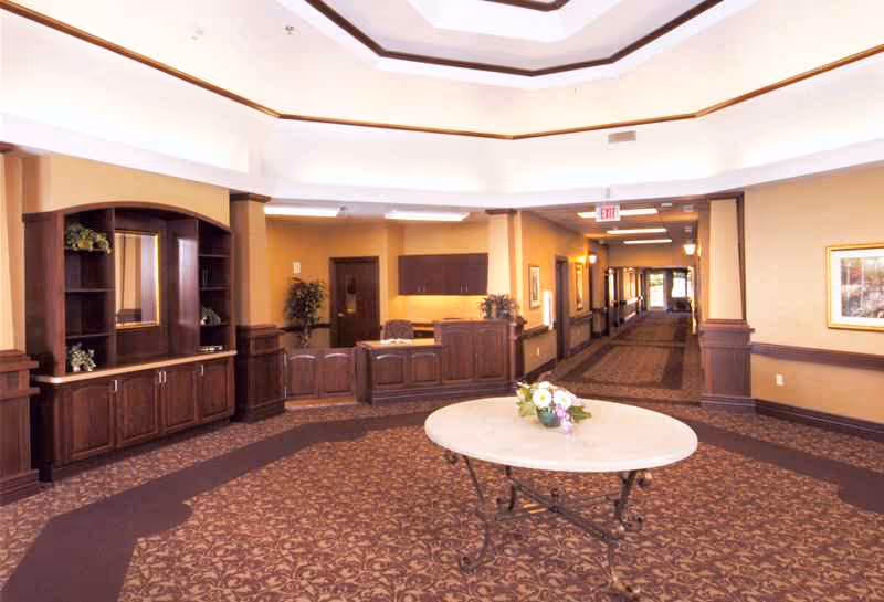 Spacious interior lobby of a senior living center with a round table.