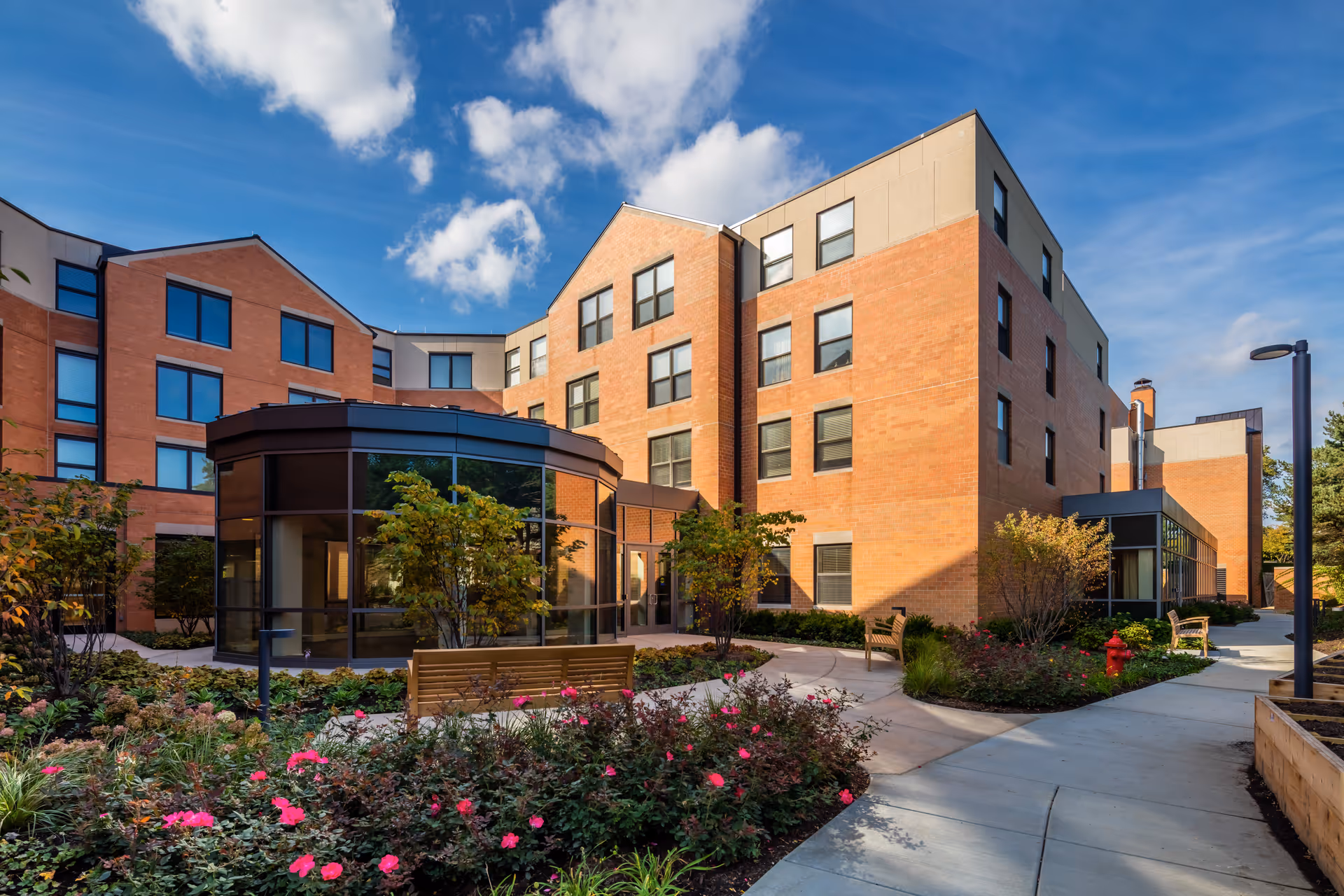 Exterior view of Mather Place building with brick facade and landscaped courtyard.