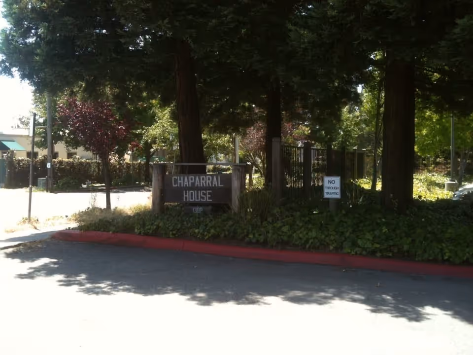 Entrance sign reading 'Chaparral House' surrounded by trees and landscaping at the facility front.