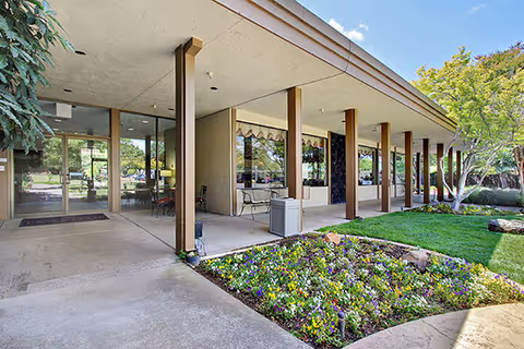 Exterior view of The Inn on Villa Lane with landscaped garden and seating area.