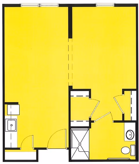 Floor plan of a small apartment or living unit with two main rooms. The left room includes a kitchenette with a sink. The right room has a bathroom with a toilet and sink, and a shower area. There are doors connecting the rooms and closets or storage spaces near the bathroom.