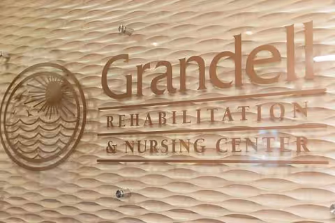Interior sign on a textured wall reading Grandell Rehabilitation and Nursing Center.