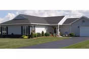 Front view of a single-story Brookside Senior Living building with a manicured lawn.