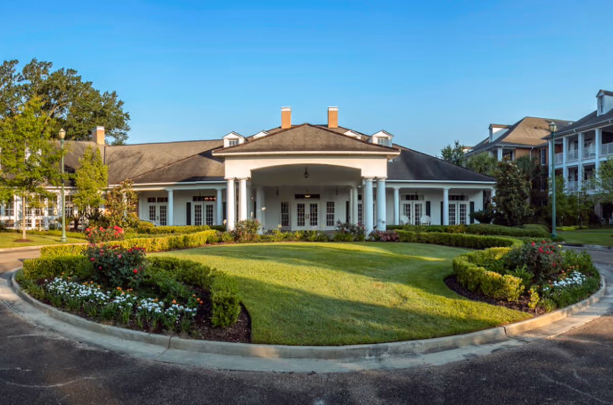 A well-maintained exterior view of St. James Place senior living facility with landscaped gardens.