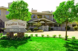 Exterior view of Paradise Villa Assisted Living with sign, entrance, and green lawn.
