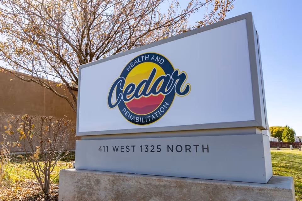 Outdoor freestanding sign for Cedar Health and Rehabilitation with the address 411 West 1325 North on a grassy lot.