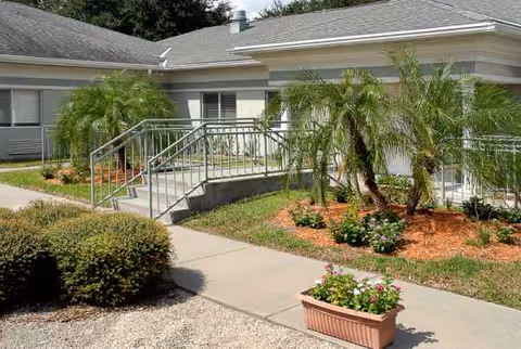 Exterior view of Life Care Center of Orange Park with ramp and landscaped entrance.