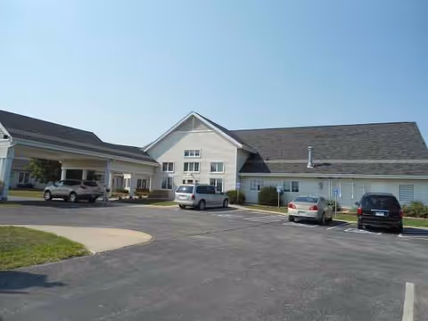 Exterior view of Hubbard Care Center with a parking lot and entrance doors