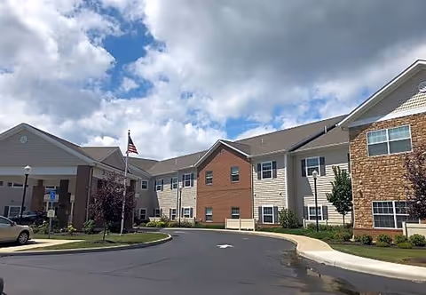 Exterior view of Danbury Broadview Heights senior living facility entrance with a curved driveway.