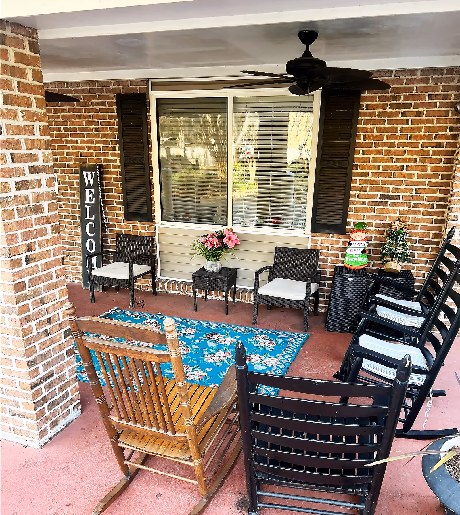 A welcoming outdoor seating area with chairs and a decorative sign.
